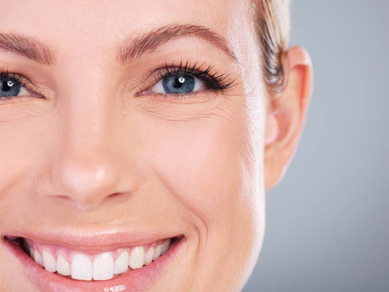 Person smiling for a dental emergency guide